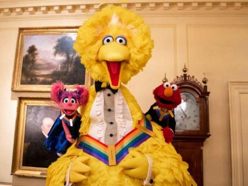 A photograph of Sesame Street characters Big Bird, Elmo and Abby at the White House