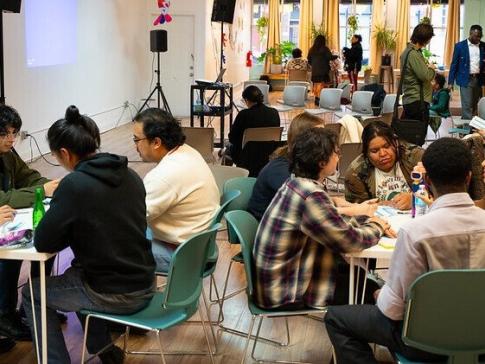 Community members in Chicago's Pilsen neighborhood sitting at tables