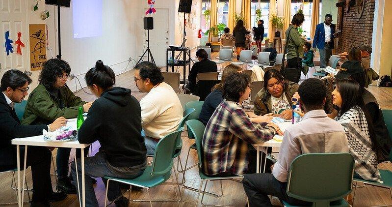 Community members in Chicago's Pilsen neighborhood sitting at tables